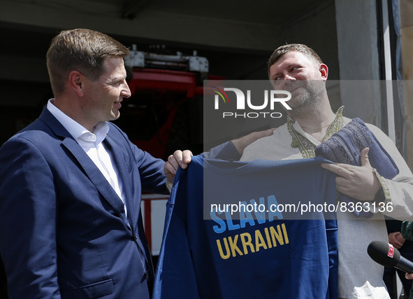 MALYN, UKRAINE - JUNE 6, 2022 - First Deputy Speaker of the Verkhovna Rada of Ukraine Oleksandr Korniienko (R) accepts a sweatshirt with the...