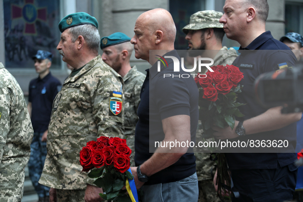 ODESA, UKRAINE - JUNE 6, 2022 - Odesa city head Hennadii Trukhanov holds a bouquet of red roses as he pays his last respects to the commande...