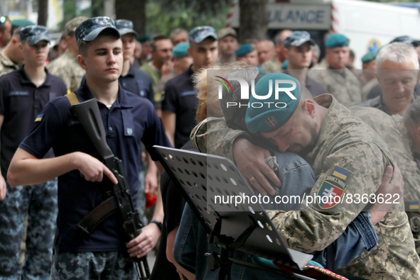 ODESA, UKRAINE - JUNE 6, 2022 - A serviceman embraces a family member to offer his condolences as he pays his last respects to the commander...