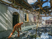 A man cleans the debrish in the entrance of his destroyed house after a russian airstrike over a civilian area of Druzhkivka, Donbass. (