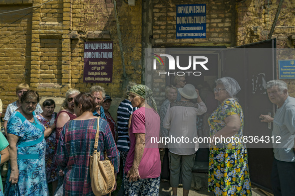 People line up to receive humanitarian aid in Kostiantynivka. The supply of some goods was reduced drastically because the hard situation of...
