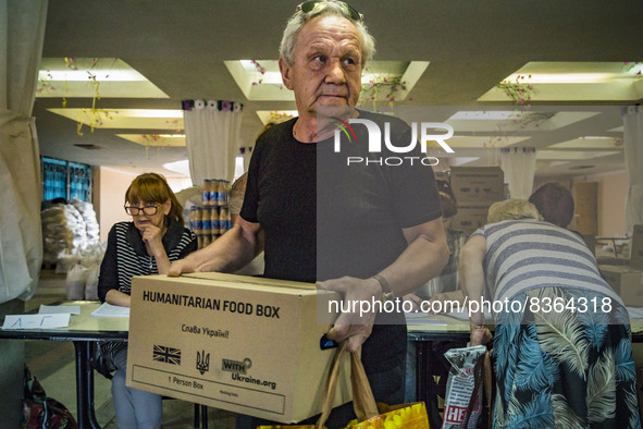 A man takes a box humanitarian aid in a city of Donbass. Supply of some food and goods stopped because the combats in many of the villages o...