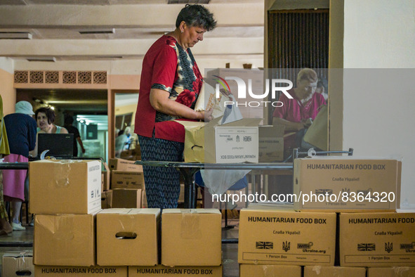 A woman takes humanitarian aid in the distribution center of Kostiantynivka. Supply of some food and goods stopped because the combats in ma...