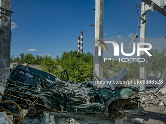 Destroyed cars and hangar after a missile attack of russian army on Mykolaivka, Donbass, on june 07, 2022.(