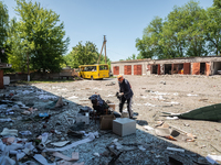 Local citizens are seen in the courtyard of the administrative building, hit last night by a Kalibr, a Russian made rocket, in the city cent...
