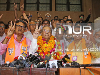  BJP Rajasthan President Satish Poonia and party candidate Ghanshyam Tiwari flash the victory sign as they celebrate the latter's victory in...