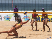 Australias’s Aracho Del Solar Maria (left) punch the ball into the Indonesia side during the Sepanjang Beach Volley Ball Asia Pacific Tourna...