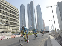 Riders pass in front of an immense five-tower skyscraper complex, called Etihad Towers (also used as a filming location for the 2015 film Fu...