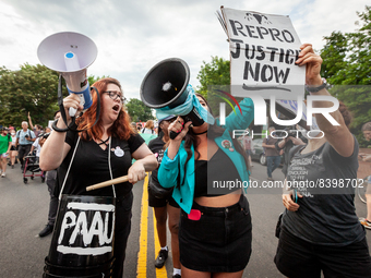 Lauren Handy (left) and Terrissa Bukovinac (center) try to interrupt a pro-choice protest and march against the leaked decision that would o...