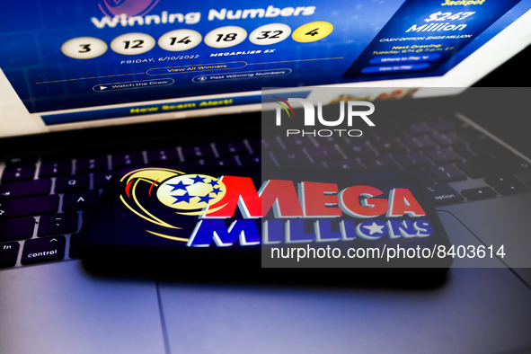 Mega Millions logo displayed on a phone screen and Mega Millions website displayed on a laptop screen are seen in this illustration photo ta...