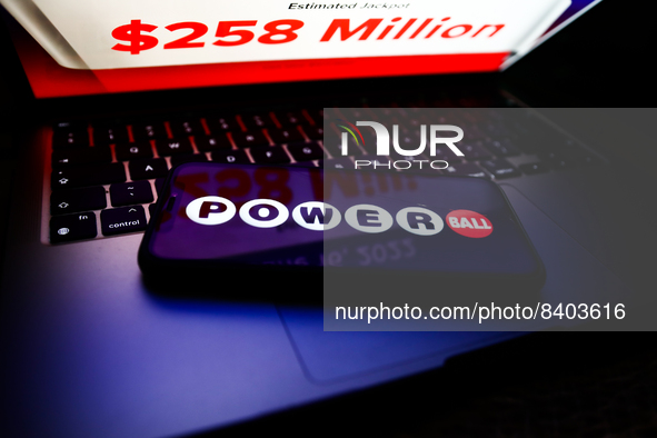 Powerball logo displayed on a phone screen and Powerball website displayed on a laptop screen are seen in this illustration photo taken in K...