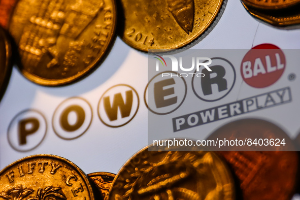 Powerball logo displayed on a phone screen and coins are seen in this illustration photo taken in Krakow, Poland on June 14, 2022. (Photo il...