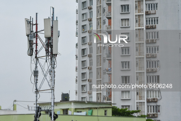 A mobile network tower is seen amidst high rises in Kolkata , India , on 16 June 2022 . India will auction 5G airwaves beginning on 26th Jul...