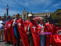 Members of the Order of Knights of Christ the King seen during the Corpus Christi procession in Krakow's Market Square.
The Feast of Corpus...