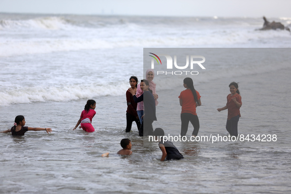 Palestinian children enjoy in the Mediterranean sea in Gaza City on June 22, 2022. 