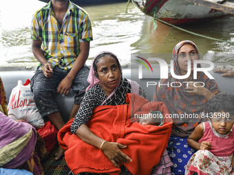 Bangladesh Navy rescue a family from a flooded area following heavy monsoon rainfalls in Sunamganj, on June 22, 2022. The people of North-Ea...