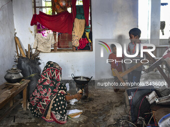 A woman cooking in shelter room at Sunamganj on June 22, 2022. The people of North-Eastern Bangladesh are experiencing the worst flooding in...