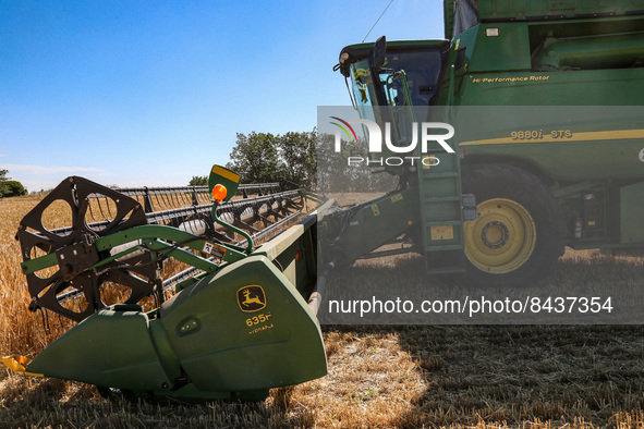 ODESA REGION, UKRAINE - JUNE 22, 2022 - A combine harvester collects grain crops in a field in Odesa Region, southern Ukraine. This photo ca...