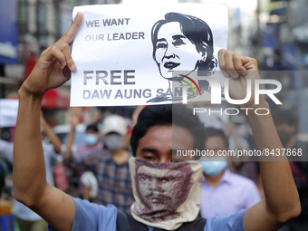 A protester holds a placard with a picture of Aung San Suu Kyi during a demonstration against the military coup in Yangon, Myanmar on Februa...