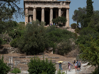 Tourists visit the temple of Hephaestus  during a heatwave in Athens, Greece, on June 23, 2022 (
