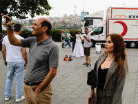 People posing with whirling dervishes in Istanbul on June 23, 2022. (