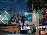 A driver's reflection is seen in a window of hydrogen bus as Poland introduces its first hydrogen bus - Urbino 12 Hydrogen into public trans...