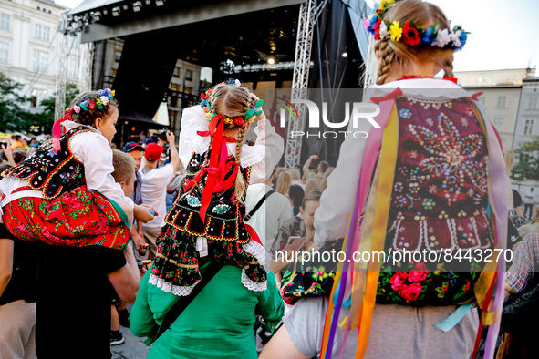 Girls dressed in Krakow folklore dresses participate in a parade of Lajkonik, a folklore tradition connected with history of Krakow in an Ol...