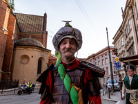 A man dressed as Tatar walks in a parade of Lajkonik, a folklore tradition connected with history of Krakow in an Old Town of Krakow, Poland...