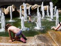 Children are having fun in a fountain at Szczepanski Square in Krakow, Poland on June 19, 2022. Hot air masses from over Africa covered most...