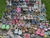 Children's shoes at a small memorial outside the Ontario Legislative Building (Queen's Park) after the discovery of the remains of 215 Indig...