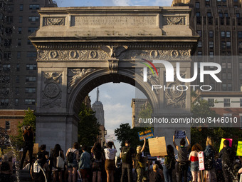 Protestors hold signs under the Washington Arch to demonstrate against the Supreme Courts decision to overturn Roe V. Wade on Friday June 24...