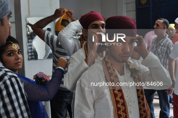 MANILA, Philippines - Young men arrange their headgear, moments before the main ceremonies of a Sikh wedding inside the Khalsa Diwan Indian...