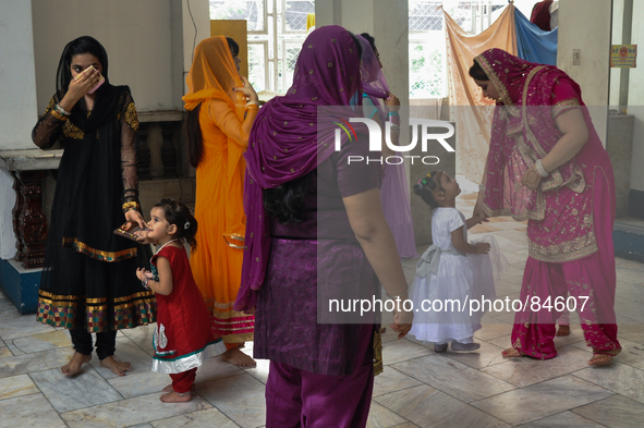 MANILA, Philippines - Women walk with their children a few moments before the main ceremonies of a Sikh wedding inside the Khalsa Diwan Indi...