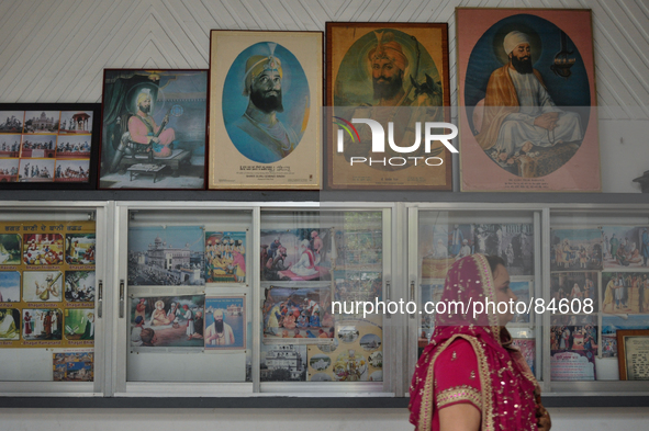 MANILA, Philippines - A woman walks past portraits of Sikh gurus, a few moments before the main ceremonies of a Sikh wedding inside the Khal...