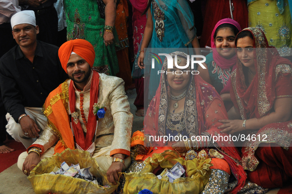 MANILA, Philippines - Family and friends pose with the bride and groom for a photo during the main ceremonies of a Sikh wedding inside the K...