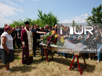 (EDITOR's NOTE: Image depicts death) A coffin with the dead in a local cemetery during the funeral mass of Andriy Krasyuk (42) an employee o...