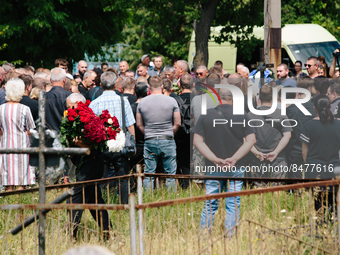 People at the funeral mass of Andriy Krasyuk (42) an employee of the electronics store, died during the russian shelling in the mall of Krem...