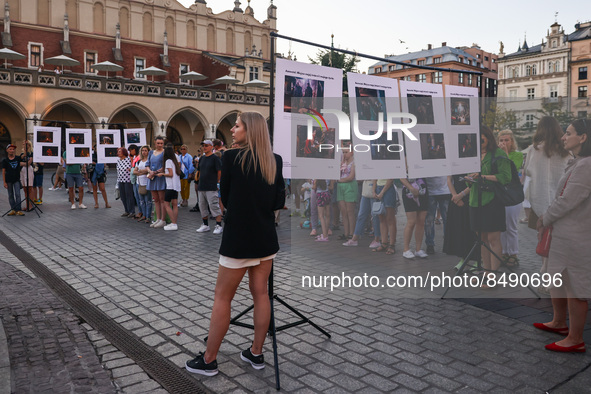 People are watching pictures by Azov soldier-photographer Dmytro 'Orest' Kozatsky, shown on outdoor temporary exhibition titled 'Azovstal -...