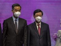 (Right) Former Hong Kong Chief Executive C.Y Leung and (Left) current Hong Kong Chief Executive John Lee posing for a photo on stage on July...