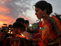 Hindu devotees release oil lamps on the Buriganga River as they observe Bipottarini Puja in Dhaka, Bangladesh on July 5, 2022. (