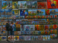 An open air art gallery, near Florianska Gate in Krakow Old Town, with paintings from local artists displayed on a wall.  
On Wednesday, Jul...