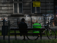 A delivery courier sits on a bench waiting for an order in the center of Krakow.
On Wednesday, July 06, 2022, in Krakow, Poland. (