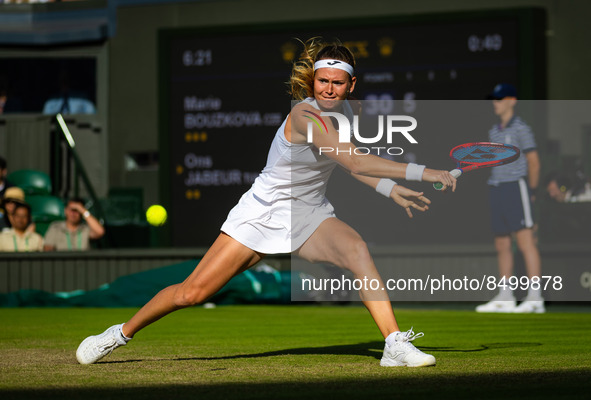 Marie Bouzkova of the Czech Republic in action against Ons Jabeur of Tunisia during the quarter-final of the 2022 Wimbledon Championships, G...