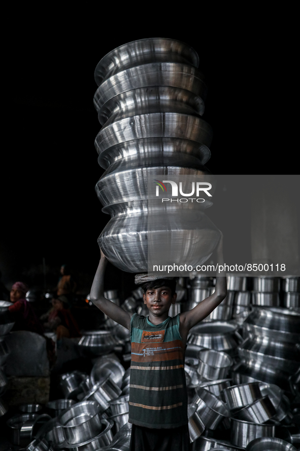 A child works inside a kitchen utensils factory at Shyampur in Dhaka, Bangladesh on July 4, 2022. 