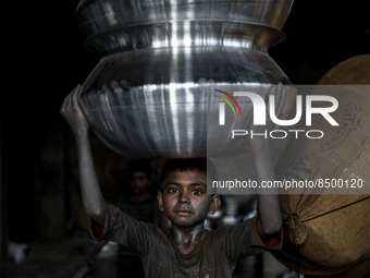 A child works inside a kitchen utensils factory at Shyampur in Dhaka, Bangladesh on July 4, 2022. (