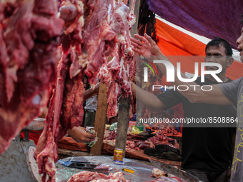 People are seen gathering at a traditional market to buy meat, as a tradition before celebrating Eid al-Adha called 'Meugang' in Lhokseumawe...