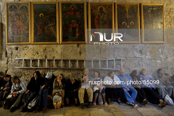 JERUSALEM, ISRAEL - APRIL 18: Orthodox Christian pilgrims take a rest inside the Church of the Holy Sepulchre on April 18, 2014 in Jerusalem...