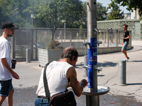 To counter the heat wave, Parisians take advantage of giant misters and water fountains, on july 19, 2022. (