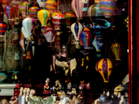 Visitors are seen in shopwindow reflection on the streets of Old Town of Krakow, Poland as the heatwave moves to central and eastern parts o...