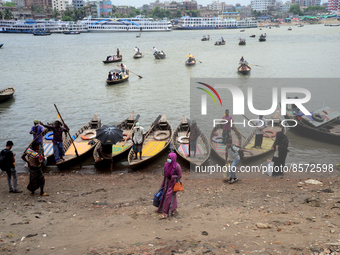 People cross the busy Buriganga river by boat during high temperature weather in Dhaka, Bangladesh, on July 22, 2022 (